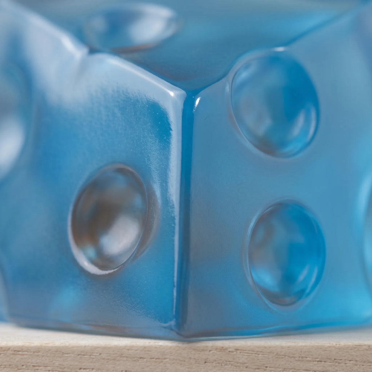 Macro view of the cool blue tint and moulded holes of the cheese squishy wedge