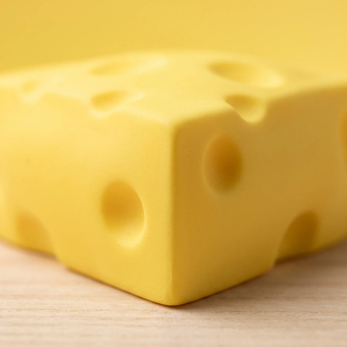 Close-up of one wedge from the cheese squishy set showing its moulded holes