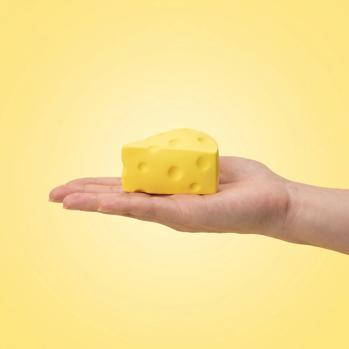 One wedge from the set held in an open hand to show its 5 cm size