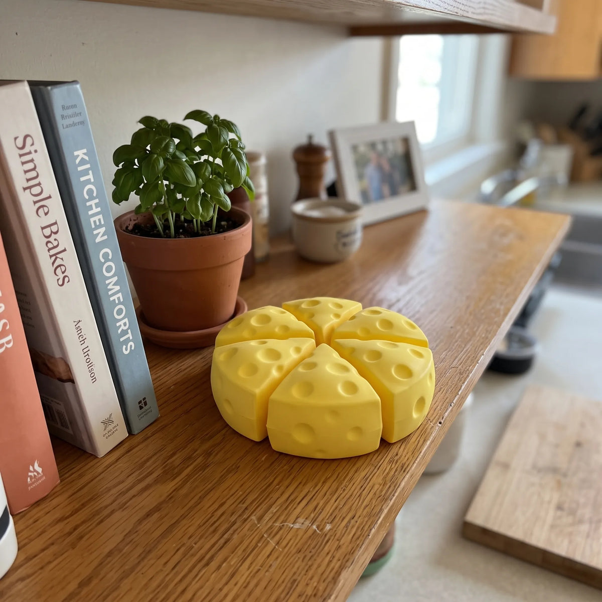 Cheese squishy wedges from the set displayed on a wooden shelf