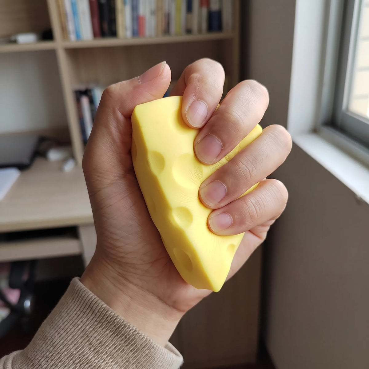 Adult hand pressing a wedge from the set flat between fingers