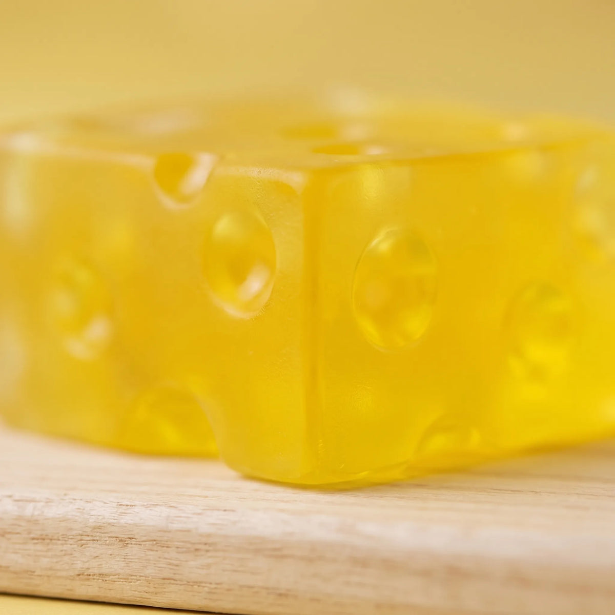 Close-up of light passing through the holes of the clear cheese squishy block