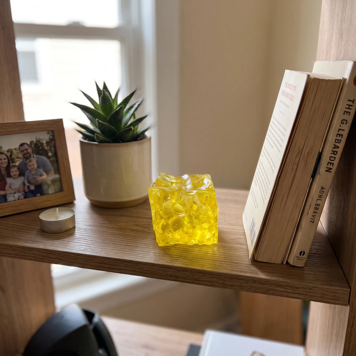 Clear cheese squishy block styled on a desk in natural light