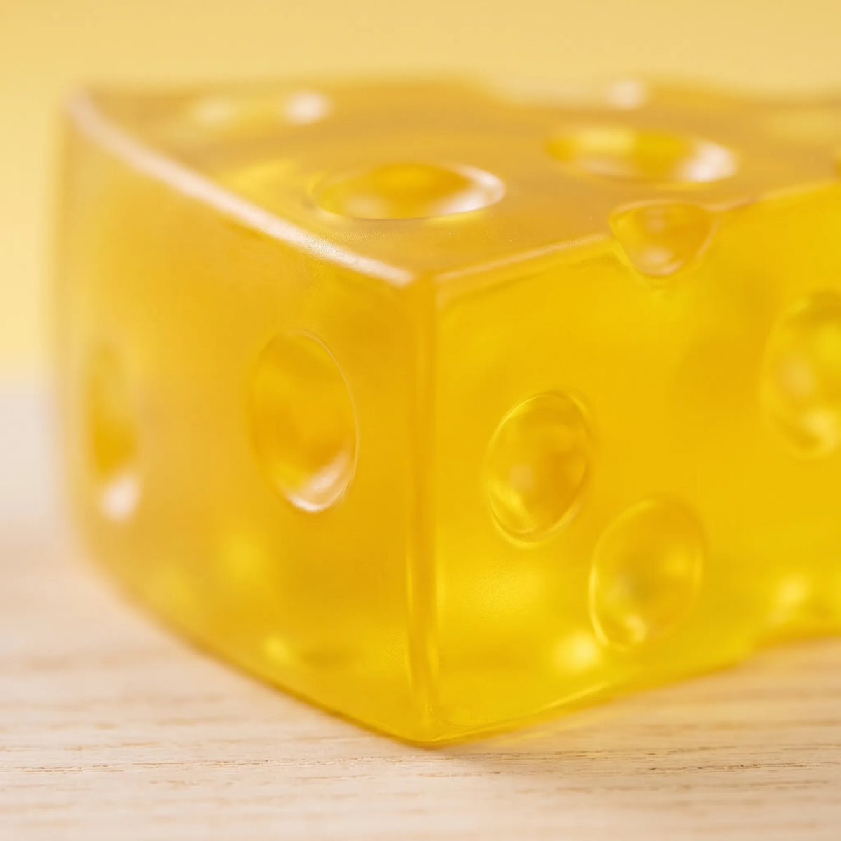 Macro view showing light passing through the translucent body of the clear cheese squishy wedge