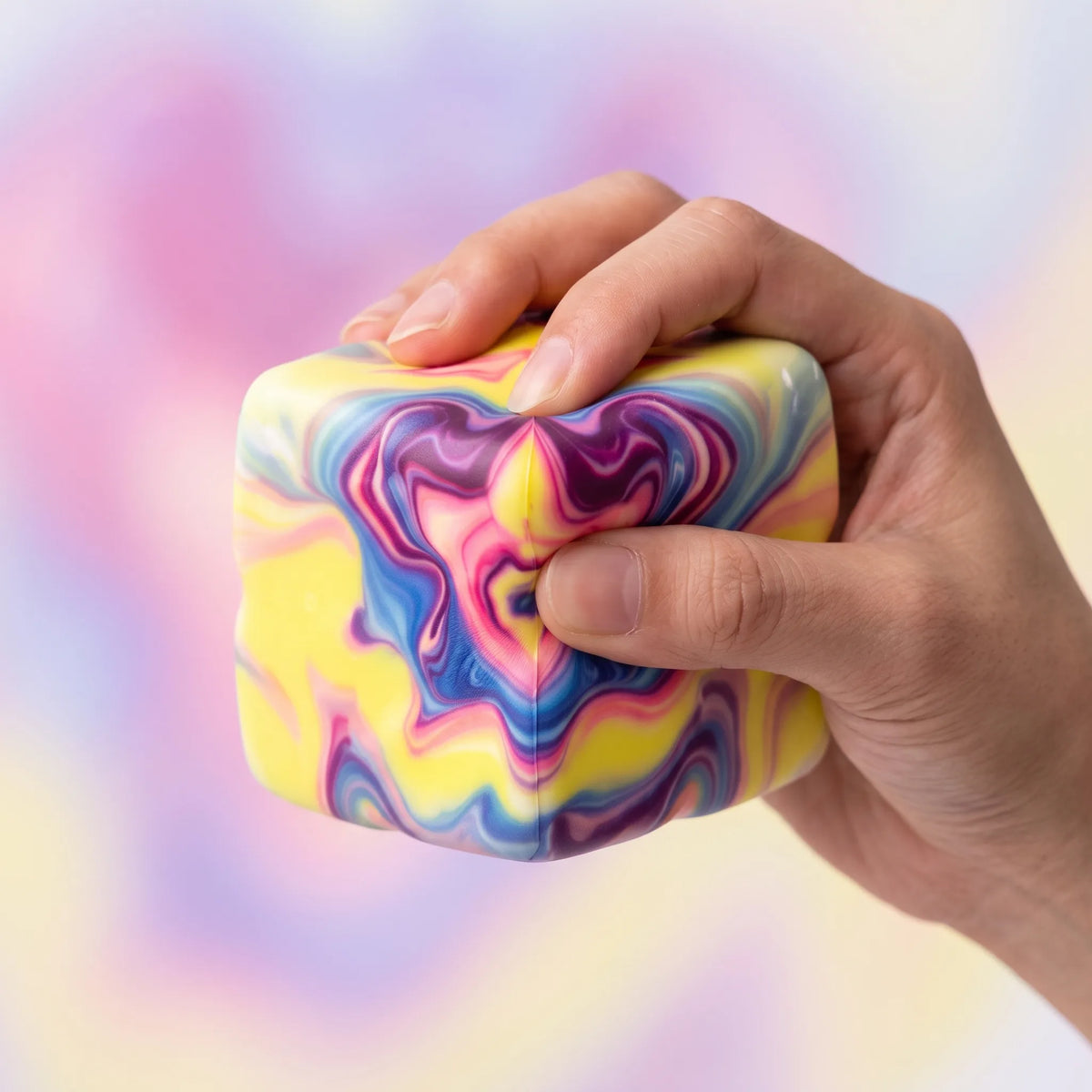 Hand squeezing the marbled purple cheese squishy block