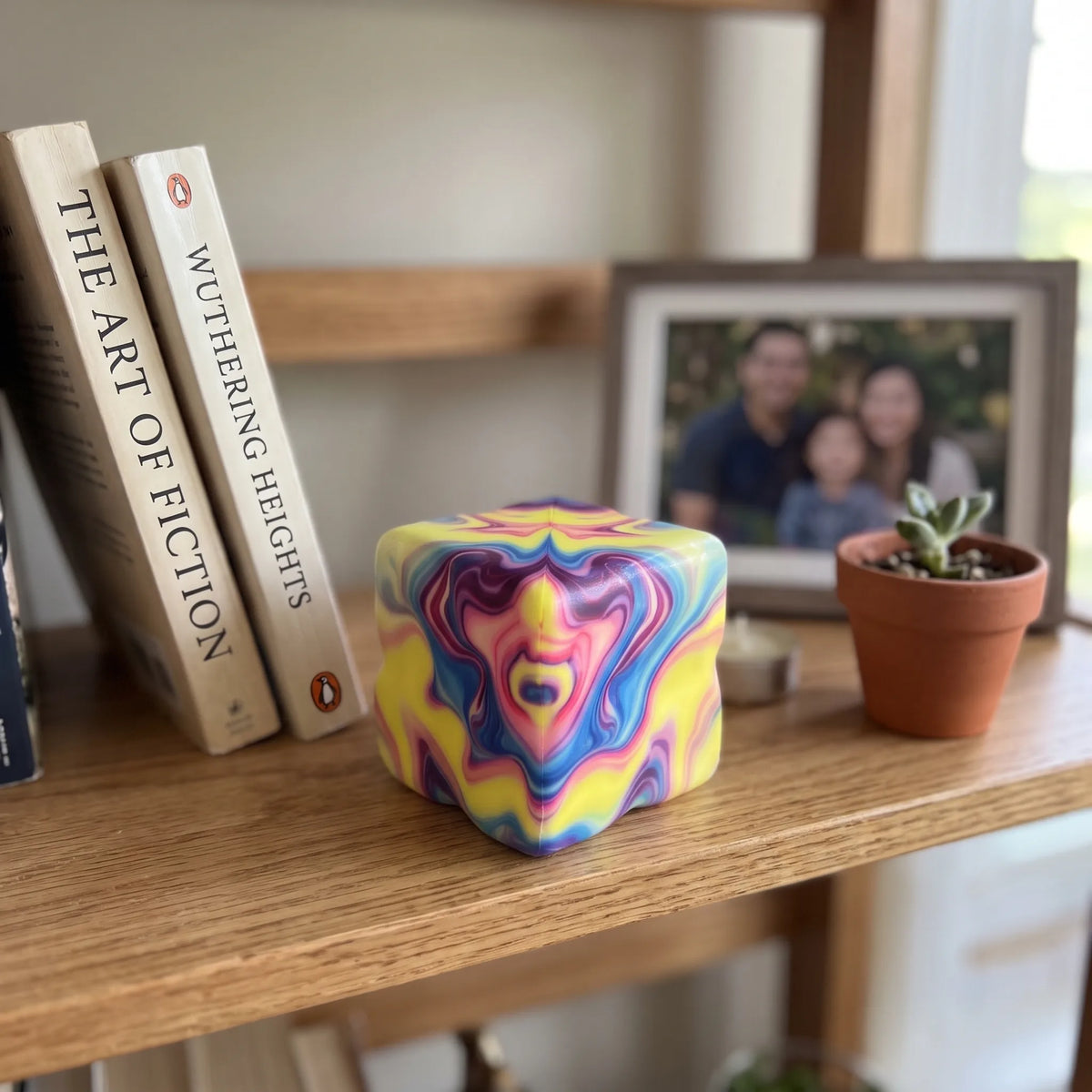 Marbled purple cheese squishy block displayed on a wooden shelf